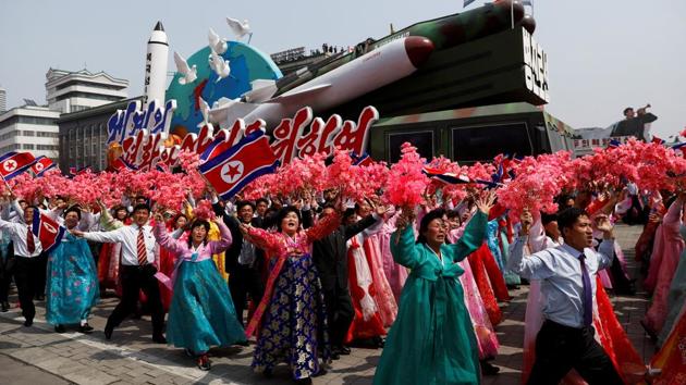 The float in the background is a stylised rocket artillery launcher, adorned with the words ‘Pyongjin Line’ on its front. (REUTERS)