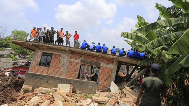 The death toll from the collapse of the massive garbage mound near Sri Lanka's capital rose to more than a dozen Sunday, and residents feared more victims could be buried underneath the debris. Maj. Gen. Sudantha Ranasinghe, who is heading the rescue efforts, said 78 houses were destroyed and more than 150 were damaged. (Eranga Jayawardena / AP)