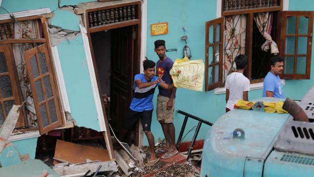 People affected by a garbage dump collapse salvage their belongings. (Eranga Jayawardena / AP)