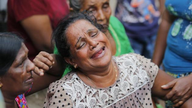 A Sri Lankan woman who lost her family members in a garbage dump collapse cries in Meetotamulla, on the outskirts of Colombo. (Eranga Jayawardena/ AP)