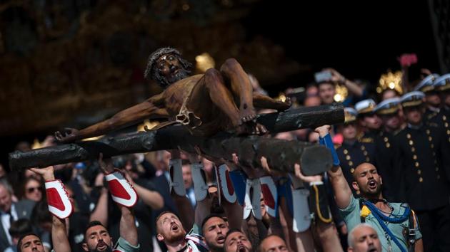 Members of the Spanish Legion carry a statue representing ‘El Cristo de la Buena Muerte’ (The Christ of the Good Death), to Santo Domingo de Guzman Church during a Holy Week procession on April 13, 2017 in Malaga, southern Spain. Christian believers around the world mark the Holy Week of Easter in celebration of the crucifixion and resurrection of Jesus Christ. (JORGE GUERRERO / AFP)