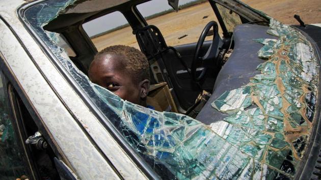 A child plays inside a destroyed vehicle in the opposition controlled town of Thonyor, in Leer county, on April 11, 2017. At least 16 civilians were killed in fighting on April 10, 2017, between government troops and rebels in South Sudan's second-largest city Wau, the United Nations peacekeeping mission (UNMISS) said in a statement. The violence stemmed from an ambush on April 11 of government troops near the city, leading to clashes in the city the following day, UNMISS said. (ALBERT GONZALEZ FARRAN / AFP)