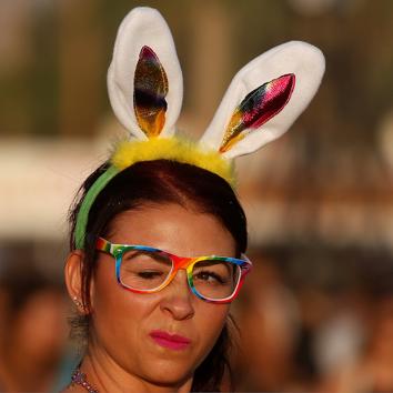 A woman walks with bunny ears in the late afternoon sun. (Carlo Allegri / REUTERS)