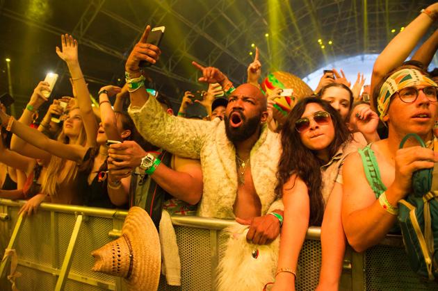 Fans of DJ Khaled dance during his performance. (VALERIE MACON / AFP)