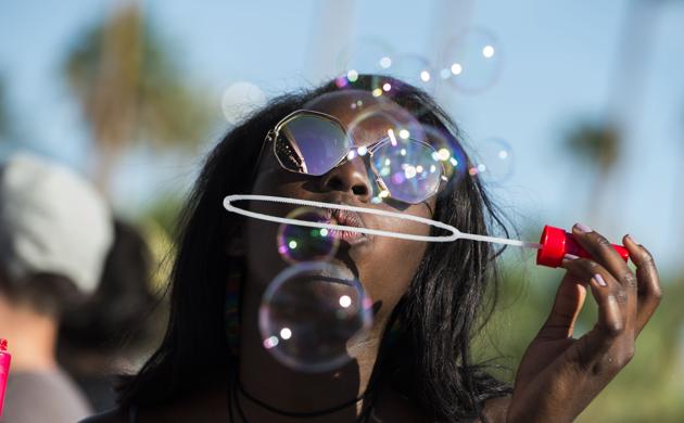 Fan plays with bubbles during the Festival. (Valerie Macon / AFP)