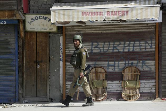 An Indian paramilitary soldier patrols during a strike in Srinagar. (Mukhtar Khan / AP)