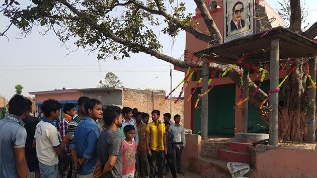 Villagers look on as the administration officials remove the disfigured statue of Ambedkar at Mirzapur Sadat village in Haridwar .(HT Photo)