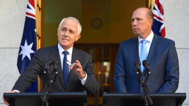 Australia’s Prime Minister Malcolm Turnbull speaks as Immigration Minister Peter Dutton listens on during a media.(Reuters photo)