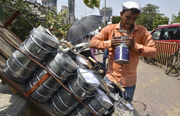 A dabbawala sorts tiffin boxes at Lower Parel on Monday. The Rs40-45-crore industry, with 5,000 delivery men, transports 2,00,000 lunch boxes daily.(Anshuman Poyrekar/HT Photo)
