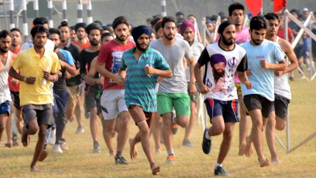Candidates participating in the physical fitness test during an army recruitment rally at Dholewal in Ludhiana on Tuesday, April 18. One of the candidates, curiously, is donning a T-shirt with a portrait of slain Sikh militant leader Jarnail Singh Bhindranwale, who was killed while fighting the army in the Golden Temple during Operation Bluestar in June 1984. (HT Photo)