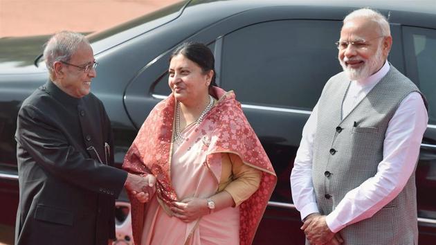 President Pranab Mukherjee shakes hands with his Nepalese counterpart Bidhya Devi Bhandari as Prime Minister Narendra Modi looks on during her ceremonial reception at Rashtrapati Bhavan in New Delhi on Tuesday. (PTI) President Pranab Mukherjee shakes hands with his Nepalese counterpart Bidhya Devi Bhandari as Prime Minister Narendra Modi looks on during her ceremonial reception at Rashtrapati Bhavan in New Delhi on Tuesday. (PTI)