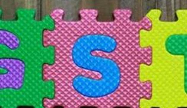 Colourful puzzle block letter with word GST on wood background.(Getty Images/iStockphoto)