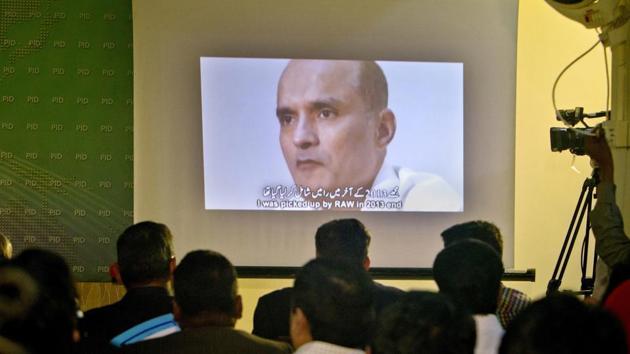 In this March 29, 2016 photo, journalists look at an image of Indian naval officer Kulbhushan Jadhav, who was arrested in March 2016, during a press conference by Pakistan’s army spokesman. Security officials said the Pakistani army officer’s abduction was aimed at pressuring Pakistan to release Kulbhushan Jadhav.(AP File Photo)