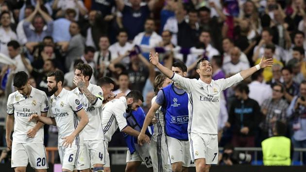 Real Madrid C.F.'s Portuguese forward Cristiano Ronaldo celebrates with teammates after completing his hat-trick in their UEFA Champions League quarterfinal second leg match Real Madrid against FC Bayern Munich at the Santiago Bernabeu on Tuesday. (AFP) Real Madrid C.F.'s Portuguese forward Cristiano Ronaldo celebrates with teammates after completing his hat-trick in their UEFA Champions League quarterfinal second leg match Real Madrid against FC Bayern Munich at the Santiago Bernabeu on Tuesday. (AFP)