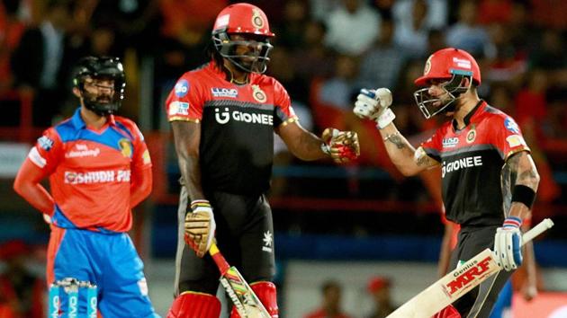 Royal Challengers Bangalore captain Virat Kohli with teammate Chris Gayle during the IPL 2017 T20 match against Gujarat Lions in Rajkot on Tuesday.(PTI)