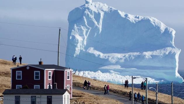 Residents view the first iceberg of the season as it passes the South Shore, also known as ‘Iceberg Alley’, near Ferryland Newfoundland, Canada. (Jody Martin / Reuters)