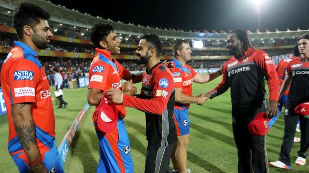 Virat Kohli shares a light moment with Munaf Patel, who returned to IPL action (vs Mumbai Indians) after a gap of almost four years. (BCCI )