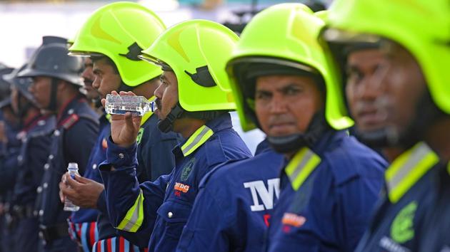 Fire officials take a break during the parade at the Gateway of India. (Pratik Chorge/HT Photo)