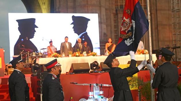 Officers lower the flag after the parade. (Pratik Chorge/HT Photo)