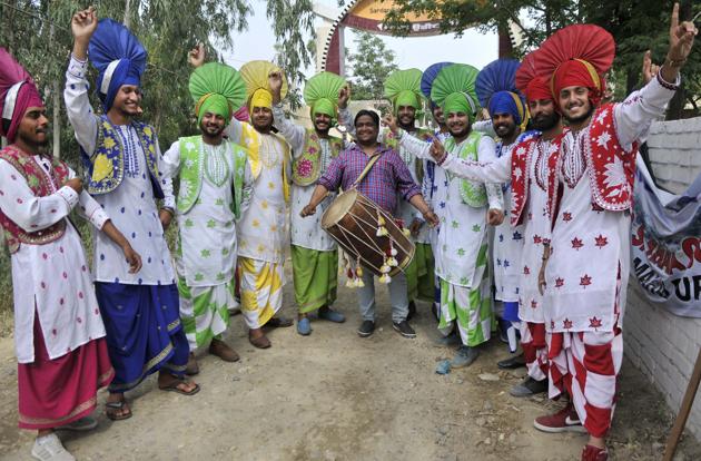 Hoshiarpur,India April 20:youngsters of village college performing bhangra in front of cavalcade of Canadian Defence Minister Harjit Singh Sajjan to welcome during his visit on his ancestral village Bombeli in distt Hoshiarpur of Punjab on Thursday, April 20, 2017.photo by Ravi Kumar/Hindustan Times