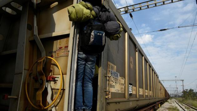 A migrant jumps on a freight train in an effort to cross the Greek-Macedonian border without documents, in the northern city of Thessaloniki, Greece. (Alexandros Avramidis /Reuters) A migrant jumps on a freight train in an effort to cross the Greek-Macedonian border without documents, in the northern city of Thessaloniki, Greece. (Alexandros Avramidis /Reuters)