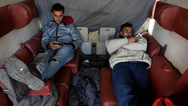 Algerian migrants rest in an abandoned railway wagon used as a shelter by stranded migrants. (Alexandros Avramidis /Reuters) Algerian migrants rest in an abandoned railway wagon used as a shelter by stranded migrants. (Alexandros Avramidis /Reuters)