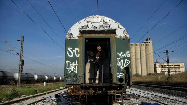 An Algerian migrant smokes inside an abandoned railway wagon. (Alexandros Avramidis /Reuters) An Algerian migrant smokes inside an abandoned railway wagon. (Alexandros Avramidis /Reuters)