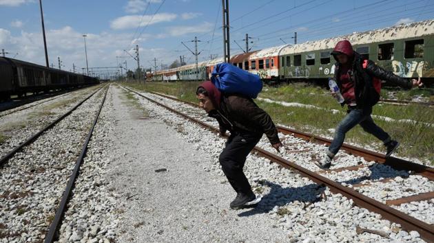 Habib (L), 22, from Algeria and a fellow migrant run to jump on a freight train in an effort to cross the border. (Alexandros Avramidis /Reuters) Habib (L), 22, from Algeria and a fellow migrant run to jump on a freight train in an effort to cross the border. (Alexandros Avramidis /Reuters)