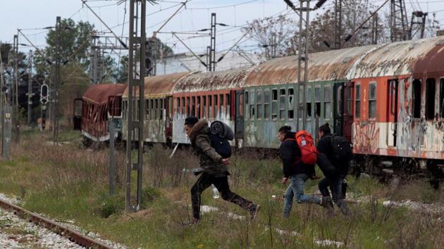 From there, they monitor freight trains heading to central Europe. Whenever trains stop in the station, the migrants try to sneak into their compartments or jump in between wagons. (Alexandros Avramidis /Reuters) From there, they monitor freight trains heading to central Europe. Whenever trains stop in the station, the migrants try to sneak into their compartments or jump in between wagons. (Alexandros Avramidis /Reuters)