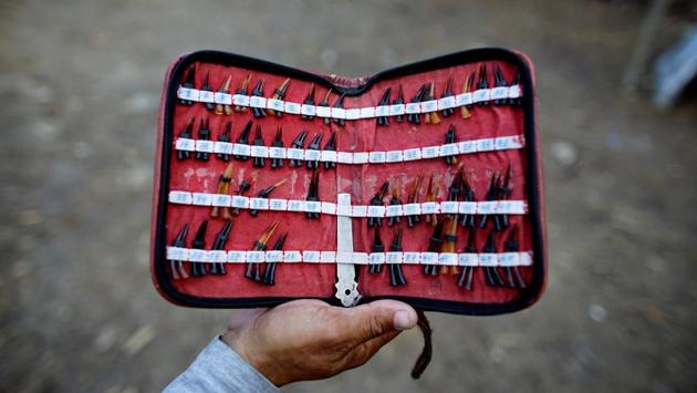 A cockfighting enthusiast shows spurs made from tortoiseshell. (Alexandre Meneghini / Reuters)