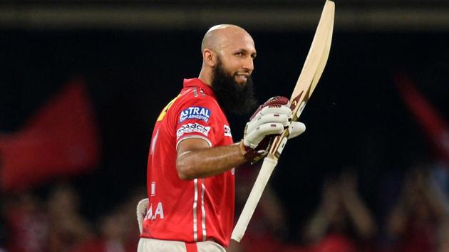 Kings XI Punjab’s Hashim Amla celebrates after scoring a century during the 2017 Indian Premier League (IPL) T20 match against Mumbai Indians at the Holkar Stadium in Indore.(AFP)