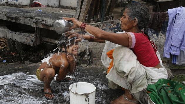 A woman bathes her child near the polluted water on Earth Day in Allahabad. (Rajesh Kumar Singh/AP) A woman bathes her child near the polluted water on Earth Day in Allahabad. (Rajesh Kumar Singh/AP)