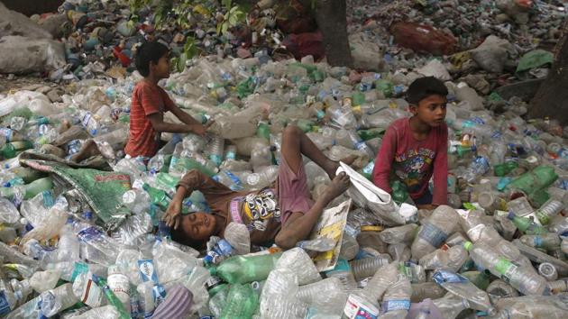 Children rest on plastic bottles after playing on Earth Day in Allahabad, India. (Rajesh Kumar Singh/AP) Children rest on plastic bottles after playing on Earth Day in Allahabad, India. (Rajesh Kumar Singh/AP)