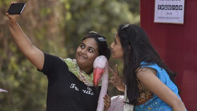 People throng to take a look of flamingos during the annual event at Sewri on Saturday. (Kunal Patil/HT Photo)