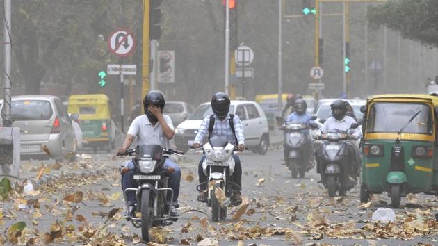 Commuters seemingly blinded by the storm that caught everyone unaware in Chandigarh on Saturday afternoon. (Ravi Kumar/HT)