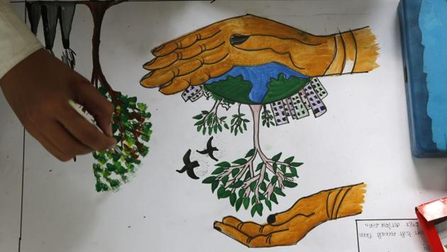 A school child draws a tree promoting conservation of the planet on world Earth Day at the Chandra Shekhar Azad Park in Allahabad. (Rajesh Kumar Singh/AP) A school child draws a tree promoting conservation of the planet on world Earth Day at the Chandra Shekhar Azad Park in Allahabad. (Rajesh Kumar Singh/AP)