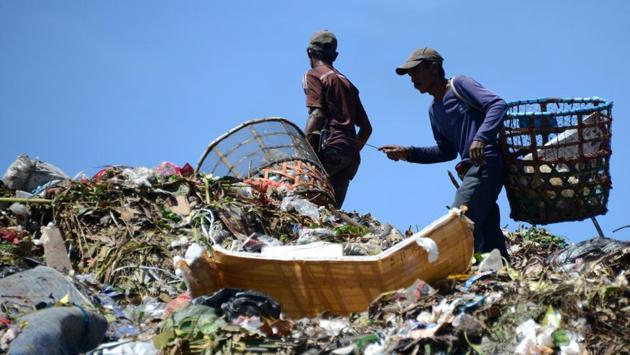 Indonesian scavengers carry items salvaged from a garbage dump in Denpasar. The theme for this year's Earth Day, which is marked on April 22, is Environmental and Climate Literacy. (Sonny Tumbelaka/AFP) Indonesian scavengers carry items salvaged from a garbage dump in Denpasar. The theme for this year's Earth Day, which is marked on April 22, is Environmental and Climate Literacy. (Sonny Tumbelaka/AFP)