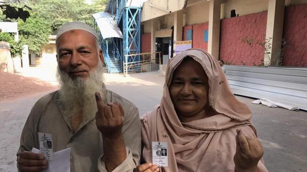 A Muslim couple shows their inked fingers after casting vote in Delhi MCD elections at Rajpura road polling station. People turning up to vote say issues, such as drinking water facilities, waste disposal, pollution, have been their main concerns and they hope for effective municipalities that can assure better basic amenities. (Ravi Choudhary/HT Photo)