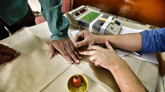 A voter gets his finger inked after voting at Burari polling station. While the BJP is attempting to fight off 10-year-old anti-incumbency, the Congress is battling an exodus of top state leaders. The AAP hopes that the civic polls will help it to recover from the jolt in assembly elections. (Arun Sharma/HT Photo)