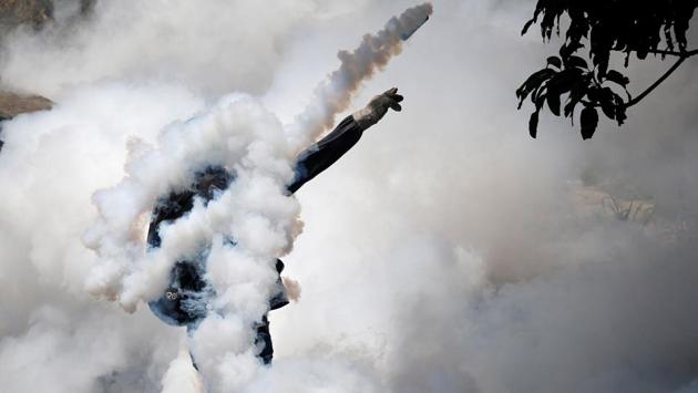 A demonstrator throws back a tear gas grenade while clashing with riot police during the so-called "mother of all marches" against Venezuela's President Nicolas Maduro in Caracas, Venezuela on April 19, 2017. (Carlos Garcia Rawlins/REUTERS) A demonstrator throws back a tear gas grenade while clashing with riot police during the so-called "mother of all marches" against Venezuela's President Nicolas Maduro in Caracas, Venezuela on April 19, 2017. (Carlos Garcia Rawlins/REUTERS)