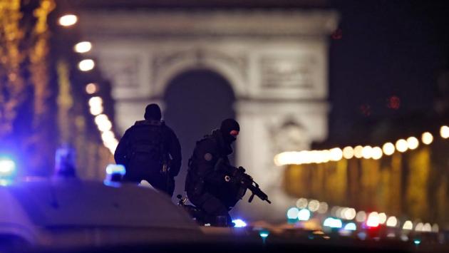 Masked police stand on top of their vehicle on the Champs Elysees Avenue after a policemen was killed and two others were wounded in a shooting incident in Paris, France on April 20, 2017. (Christian Hartmann/REUTERS) Masked police stand on top of their vehicle on the Champs Elysees Avenue after a policemen was killed and two others were wounded in a shooting incident in Paris, France on April 20, 2017. (Christian Hartmann/REUTERS)