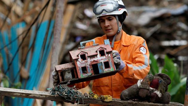 A rescue member finds a toy house in a destroyed area after mudslides caused by heavy rains leading several rivers to overflow, pushing sediment and rocks into buildings and roads, in Manizales, Colombia on April 20, 2017. (Santiago Osorio/REUTERS) A rescue member finds a toy house in a destroyed area after mudslides caused by heavy rains leading several rivers to overflow, pushing sediment and rocks into buildings and roads, in Manizales, Colombia on April 20, 2017. (Santiago Osorio/REUTERS)