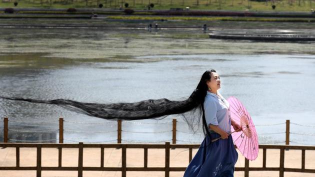 A woman with long hair poses for pictures in Weihai, Shandong province in China on April 22,. (REUTERS) A woman with long hair poses for pictures in Weihai, Shandong province in China on April 22,. (REUTERS)