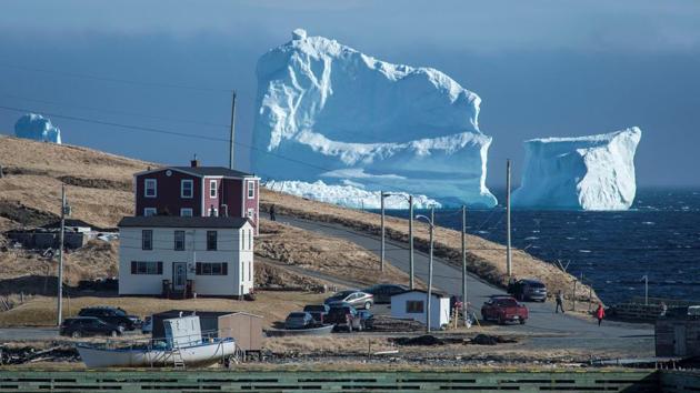 Residents view the first iceberg of the season as it passes the South Shore, also known as "Iceberg Alley", near Ferryland Newfoundland, Canada on April 16, 2017. (Greg Locke/REUTERS) Residents view the first iceberg of the season as it passes the South Shore, also known as "Iceberg Alley", near Ferryland Newfoundland, Canada on April 16, 2017. (Greg Locke/REUTERS)