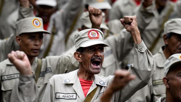 Members of the Bolivarian Militia take part in a parade in the framework of the seventh anniversary of the force, in front of the Miraflores presidential palace in Caracas on April 17, 2017. Venezuela's defence minister on Monday declared the army's loyalty to Maduro, who ordered troops into the streets ahead of a major protest by opponents trying to oust him. Venezuela is bracing for what Maduro's opponents vow will be the "mother of all protests" Wednesday, after two weeks of violent demos against moves by the leftist leader and his allies to tighten their grip on power. (Federico Parra/AFP) Members of the Bolivarian Militia take part in a parade in the framework of the seventh anniversary of the force, in front of the Miraflores presidential palace in Caracas on April 17, 2017. Venezuela's defence minister on Monday declared the army's loyalty to Maduro, who ordered troops into the streets ahead of a major protest by opponents trying to oust him. Venezuela is bracing for what Maduro's opponents vow will be the "mother of all protests" Wednesday, after two weeks of violent demos against moves by the leftist leader and his allies to tighten their grip on power. (Federico Parra/AFP)