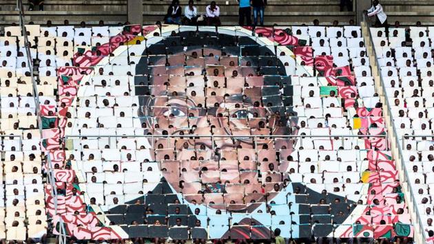 School children hold an image of Zimbabwe's President Robert Mugabe during the country's 37th Independence Day celebrations at the National Sports Stadium in Harare on April 18, 2017. (Jekesai Njikizana/AFP) School children hold an image of Zimbabwe's President Robert Mugabe during the country's 37th Independence Day celebrations at the National Sports Stadium in Harare on April 18, 2017. (Jekesai Njikizana/AFP)
