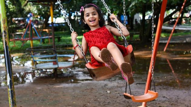 Children Playing On Playground In City Park Engaged In Football