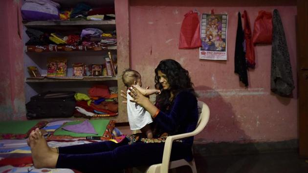 Pooja plays with her daughter at her home.  Pooja, a native of Ludhiana was introduced to Pandey by choreographer of a Bhojpuri music album she was working on. Pooja did not think very highly of live dancing until Pandey persuaded her to give it a shot. Four years later, she married Pandey and became the ‘star performer’ of his troupe. (Ravi Choudhary/HT PHOTO) 