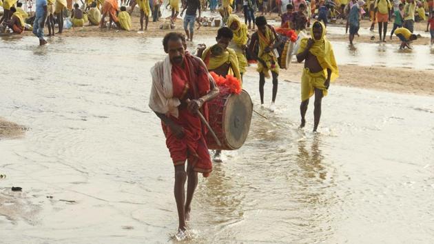 Dressed in red, yellow and saffron devotees move out in the morning amidst beating of drums and blowing of conch shells and trumpet. (Arabinda Mahapatra / HT Photo)