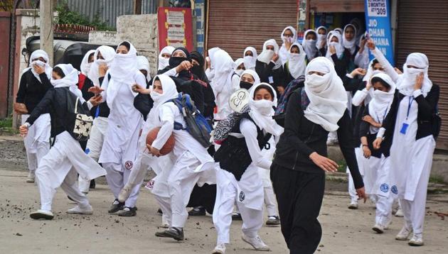 Girl students pelt stones at security personnel during clashes in the vicinity of Lal Chowk in Srinagar on April 24.(PTI Photo)